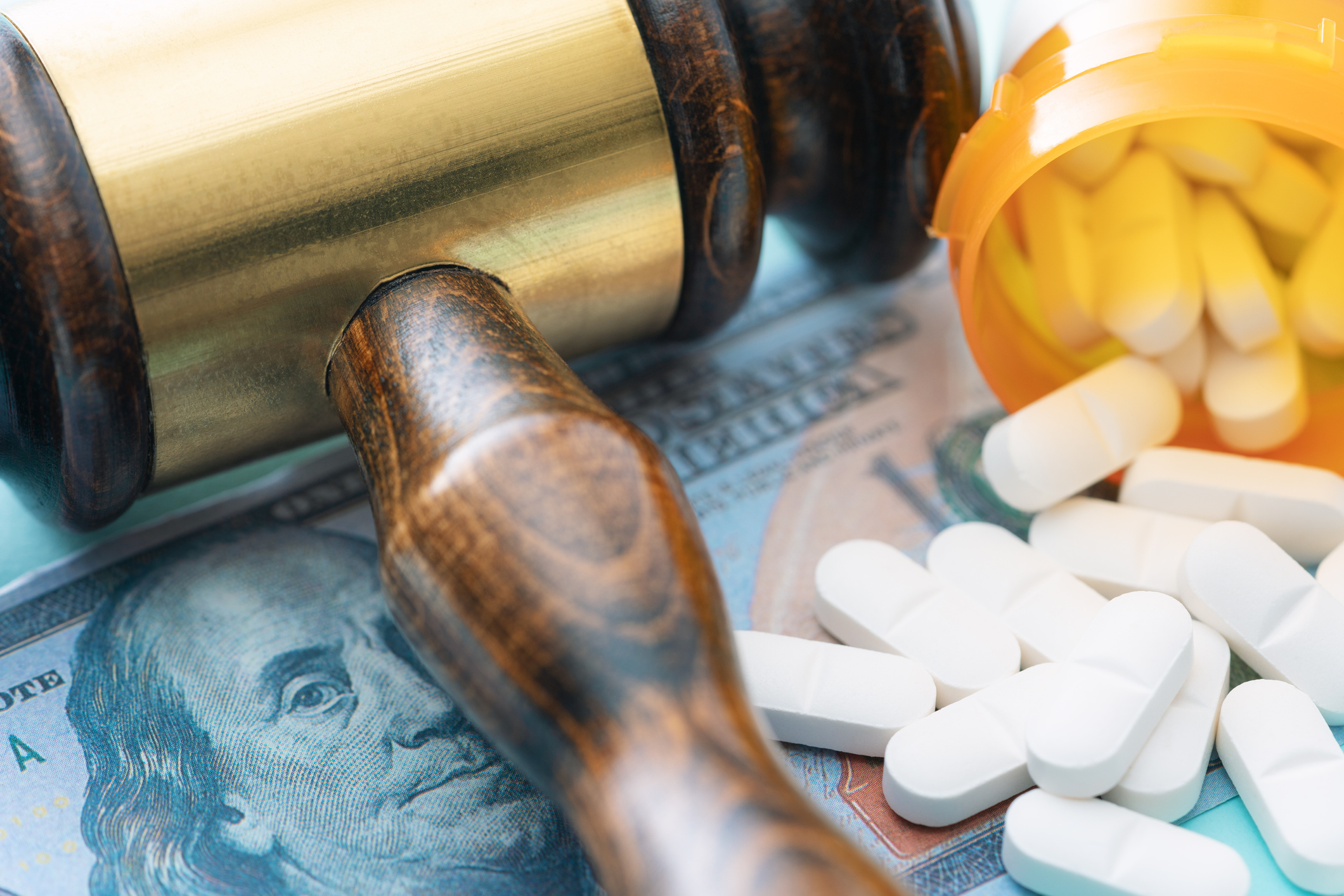 gavel-on-top-of-money-and-pills