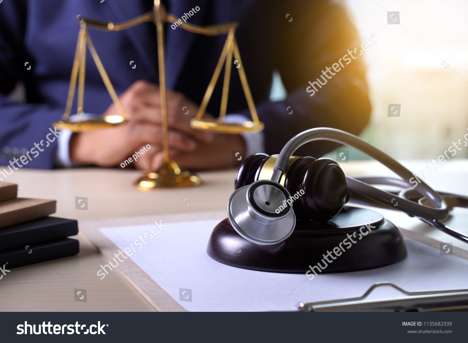 lawyer-at-desk-with-justice-scale-and-stethoscope